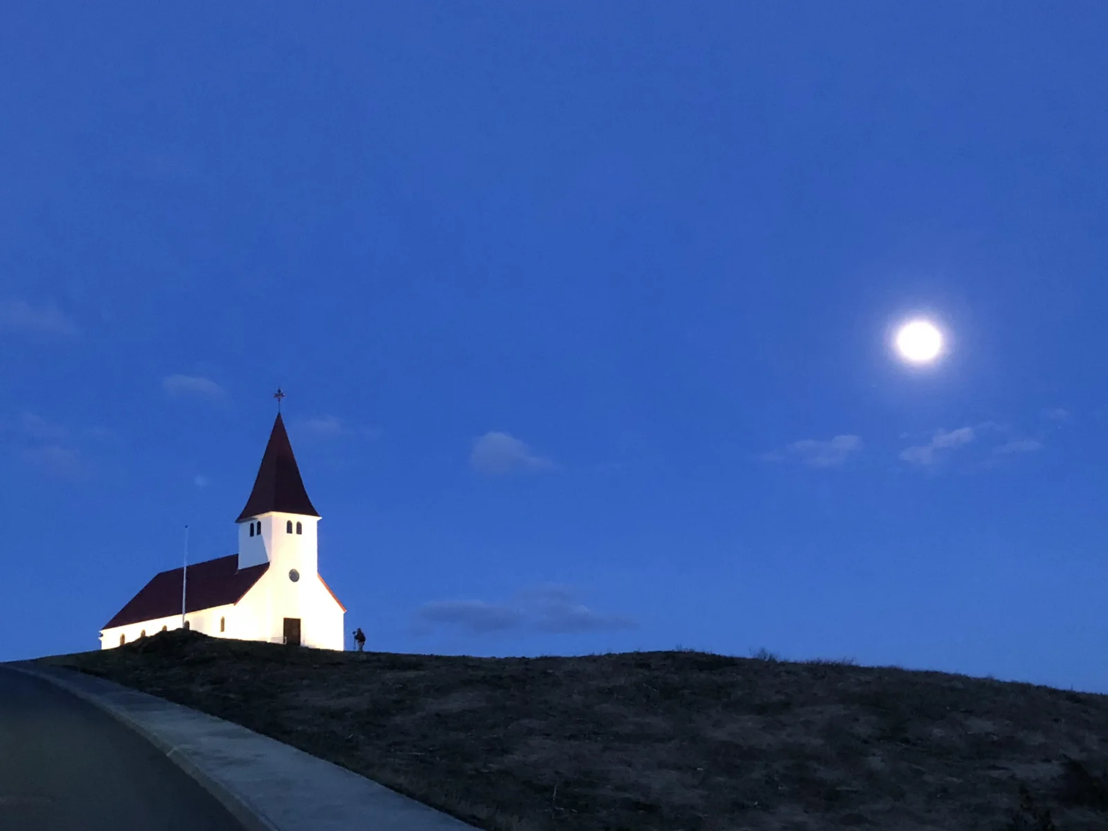 Coming back from the trigger faster each time. That's the whole skill. | A church at dusk in Iceland, on repair and returning in relationships, Love Unlocked.